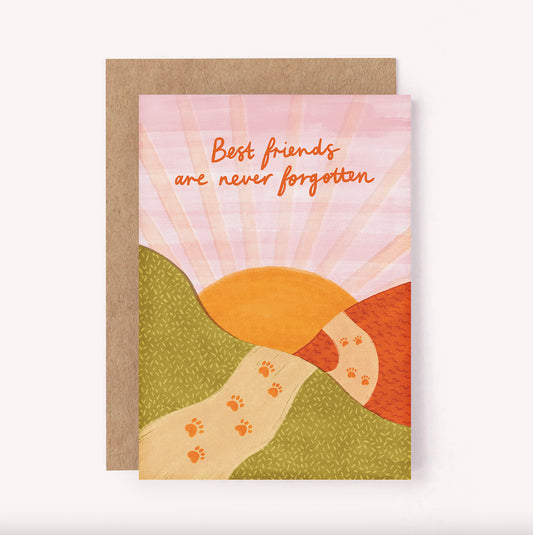 Send condolences to someone who has lost a dear pet with this illustrated "Best Friends are Never Forgotten" pet loss sympathy card. The sun is setting against a pink sky, and a path has paw prints on as it fades over rolling hills.