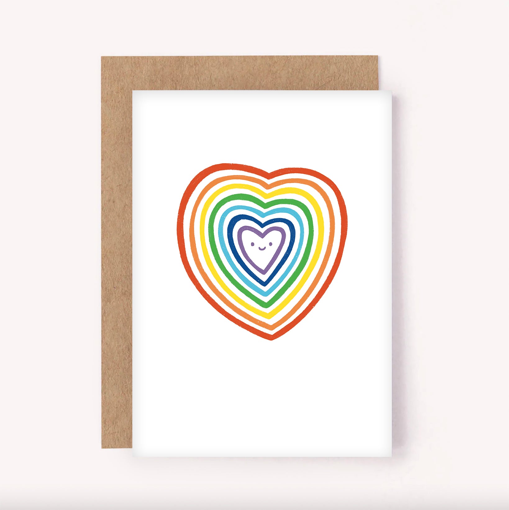 This colourful card is sure to bring joy. Featuring a sweet illustrated rainbow heart with smiling face, on a white background. It's simple design makes it perfect for so many occasions - Valentines Day, an anniversary, engagement, wedding, celebrating Pride or simply sending a rainbow someone's way.