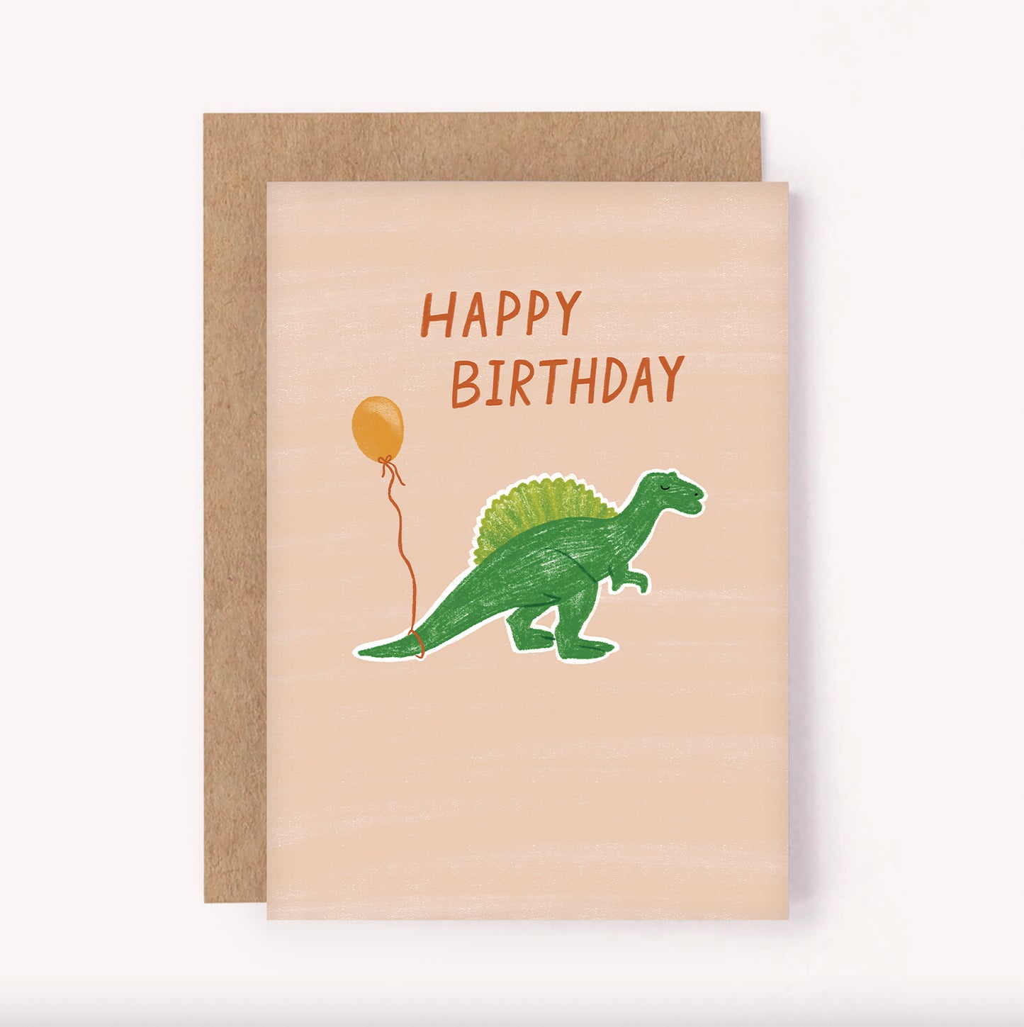 Cute, illustrated birthday card featuring a dinosaur with a balloon tied to its tail and hand-lettered "Happy Birthday". Beige background with green dinosaur, perfect for a children's birthday