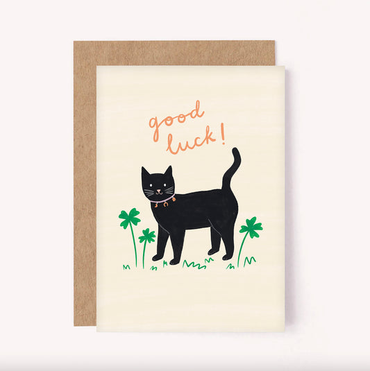 This illustrated good luck card is perfect for sending some confidence to a friend or loved one. This black cat wears a cute collar with lucky charms on - a moon, horseshoe and dice and is surrounded by lucky green four-leaf clovers