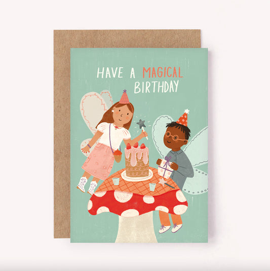 “Have a Magical Birthday” illustrated children's birthday card with two fairies. They are enjoying a picnic on a mushroom with party hats and presents. Perfect birthday card for kids of all ages