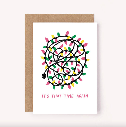 This holidays card is a relatable one! Featuring an illustrated pile of tangled Christmas fairy lights with the greeting "It's That Time Again"