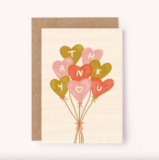Send a bunch of heart shaped balloons to say thank you with this illustrated greeting card. Hand-lettered "Thank You" is spelt out on pink and gold balloons on a beige background. This sweet, simple design is the perfect way of showing some appreciation