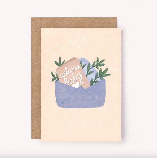 "Welcome Baby" greeting card, perfect for a baby shower or welcoming a new arrival. Set on a beige background is an envelope with a handwritten note announcing baby's arrival and some sweet foliage. The simple colour palette makes it a perfect gender neutral design